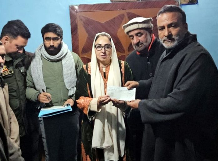 Waqf Board Chairperson handing over cheque to a victim at Hazratbal shrine in Srinagar. Waqf Board Chairperson handing over cheque to a victim at Hazratbal shrine in Srinagar.