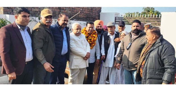 NC Leader Ajay Kumar Sadhotra posing along with party workers in Jammu on Monday.