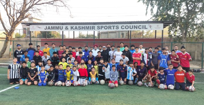 Players posing for a group photograph during football coaching camp at Parade Ground, Jammu.