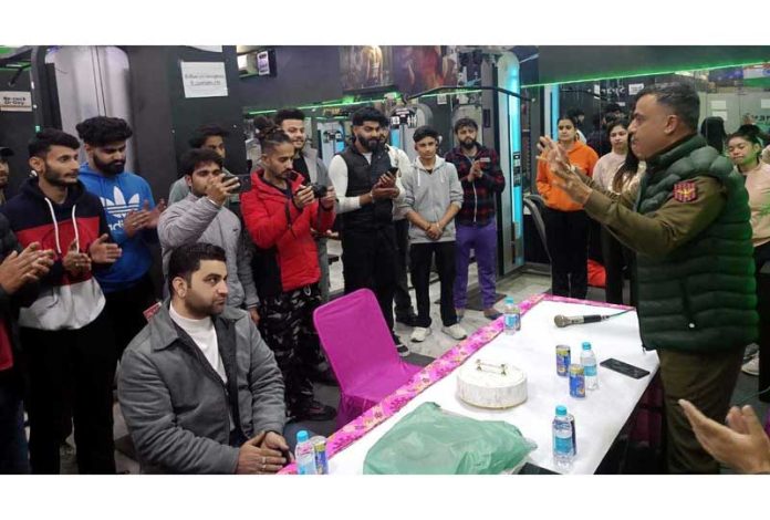 Police officer briefs people on drug menace.