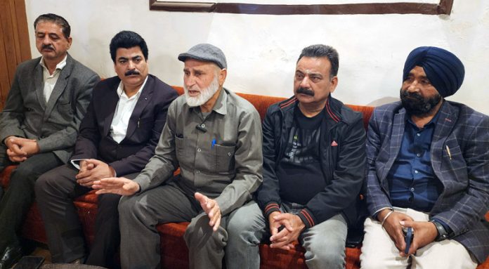 Mohd Gafoor Dar, president National Trade Union Front, flanked by others talking to media-persons in Jammu. -Excelsior/ Rakesh