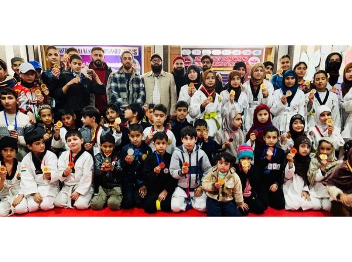 Wushu players posing along with dignitaries during District Championship at Doda.