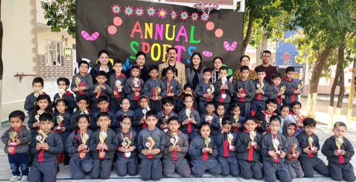 Students alongwith trophies posing for a photograph.