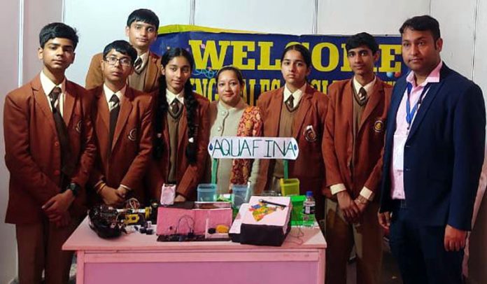 Students of Spring Dales English School along with their guide, posing with their innovative projects at National Startup Festival 2025.
