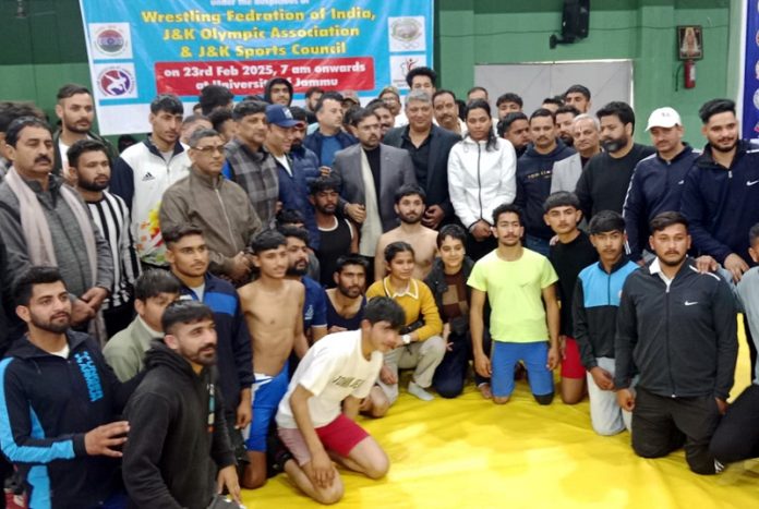 Sports Minister Satish Sharma and dignitaries posing for a photograph with wrestlers at Jammu University.