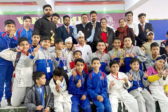 Karate athletes posing for group photograph with dignitaries during an event at Jammu.