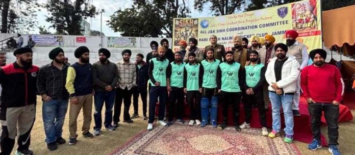 Players and others pose for a photograph after a match in the ongoing First Sikh Cricket Premier League at Jammu on Saturday.