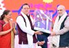 Chief Minister Pushkar Singh Dhami presenting a memento to Home Minister Amit Shah during closing ceremony of 38th National Games.