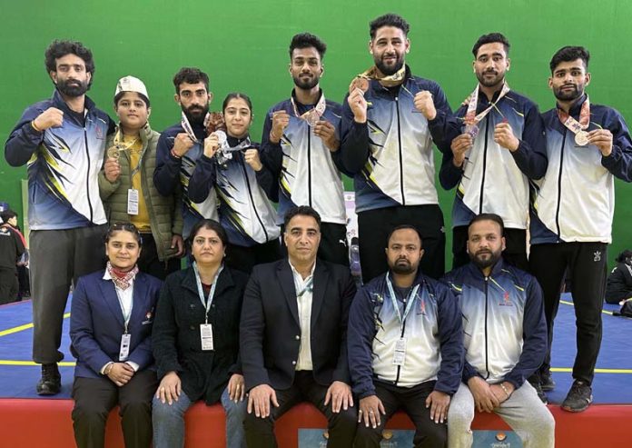J&K Wushu team posing with coaching staff after their impressive performance at 38th National Games.