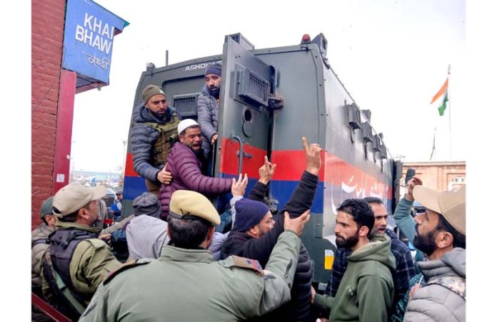 Casual labourers being detained by police ahead of a proposed protest in Srinagar on Monday. -Excelsior/Shakeel