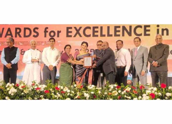 Representative of SMVD Narayana Hospital receiving AHPI Digital Health Excellence Award.