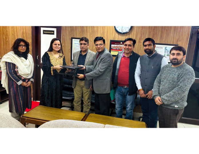 JU Registrar Dr Neeraj Sharma and others exchanging a copy of MoU.