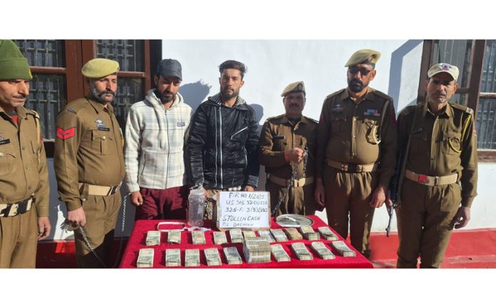 Police presenting two persons involved in a bank theft in Kishtwar. — Excelsior/Tilak Raj