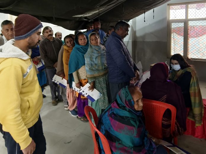 Patients waiting for their turn for checkup during a medical camp at Jourian in Jammu.