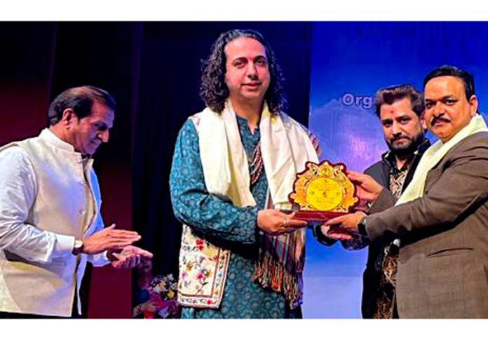 Pandit Abhay Rustum Sopori receiving an award during a function held on Sunday.