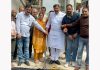 MLA Jammu West, Arvind Gupta, posing with others during the macadamization work at Bharat Nagar.