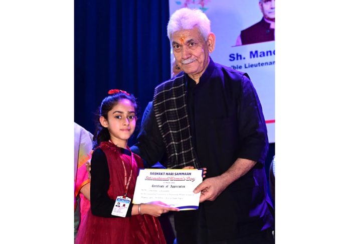 LG Manoj Sinha felicitating a girl during 'Sashakt Nari Samman' event at Jammu on Saturday.