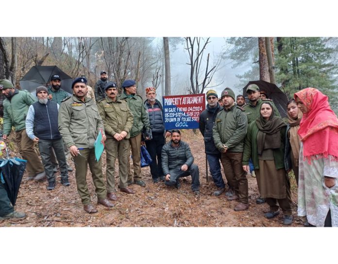 Cops at the site of attached property of a terrorist in Gool area of Ramban district on Friday. — Excelsior/Parvez Mir Cops at the site of attached property of a terrorist in Gool area of Ramban district on Friday. — Excelsior/Parvez Mir