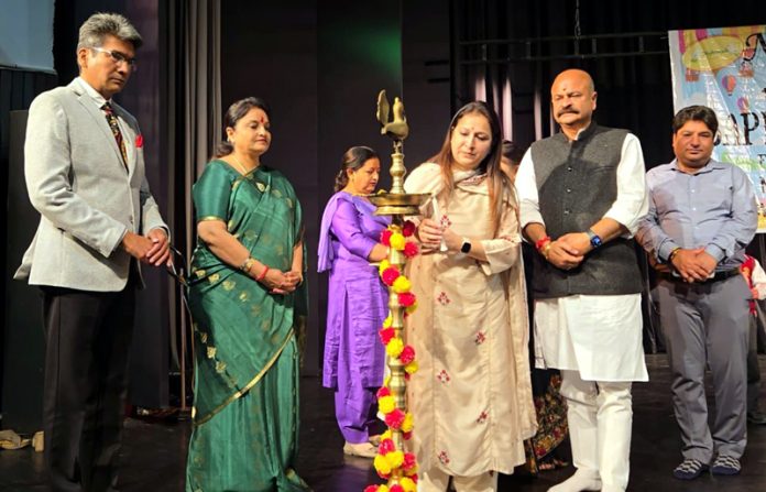 Chief Guest lighting traditional lamp during a programme in Jammu.