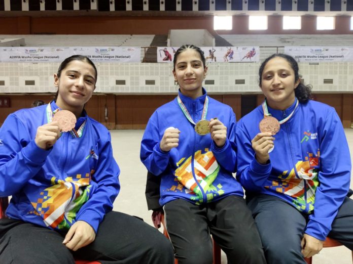 J&K Wushu athletes showing medals during Khelo India Wushu Women’s League Championship held at Bilsapur.