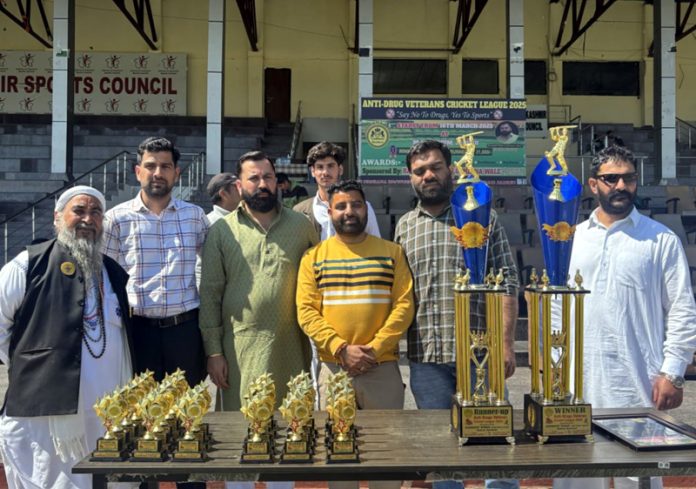 Dignitaries posing during a cricket match at MA Stadium.