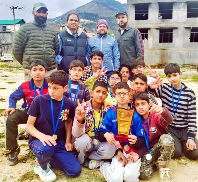 Young budding cricket players posing during a match at Doda.