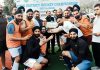 Players posing along with trophy at Poonch.