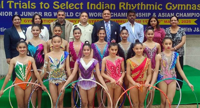 Gymnasts along with others pose for photograph after selection trials in Jammu on Tuesday.