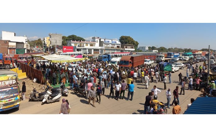 Locals staging a demonstration on the Jammu-Pathankot National Highway in Jatwal area on Thursday.