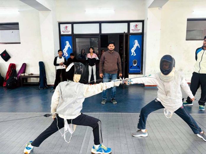 Fencers in action during selection trials at Jammu.