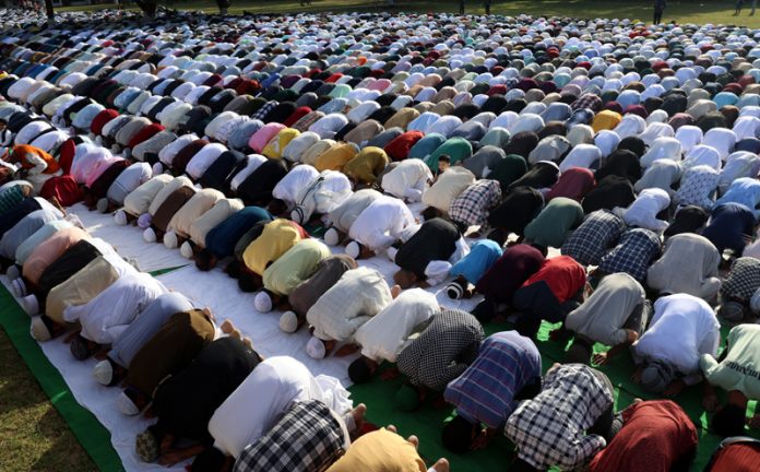 Members of Muslim community offering special Eid prayers at Eidgah Residency Road, Jammu on Monday. — Excelsior /Rakesh