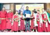 A dignitary presenting certificate to a group of student leaders during a programme at Leh.