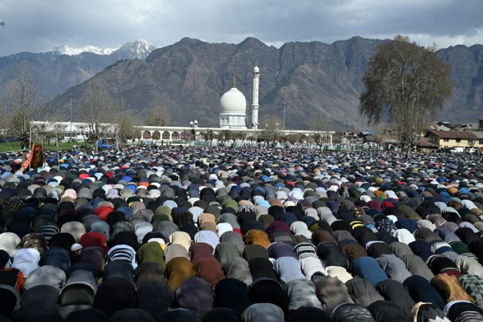 Devotees pray at Hazratbal shrine in Srinagar on the last Friday at Ramadan. -Excelsior/Shakeel