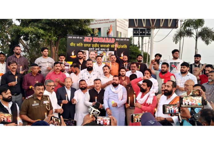 Members of Yuva Rajput Sabha and others taking out candle march at Jammu on Monday.