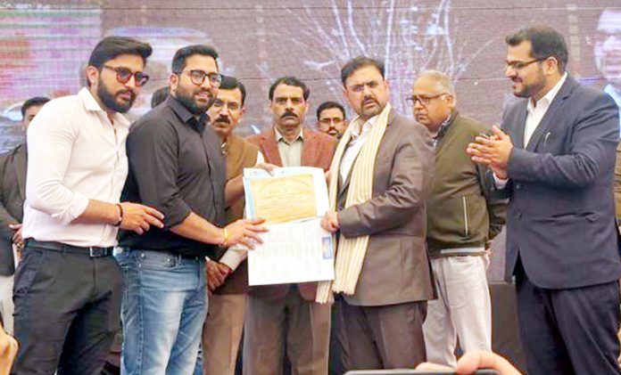 Minister Satish Sharma distributing certificate during awareness camp organized by JPDCL.