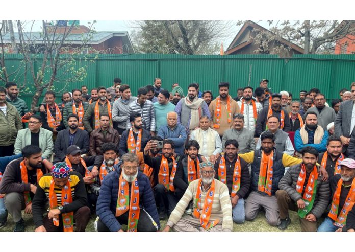 BJP JK UT president, Sat Sharma and party general secretary, Ashok Koul taking new entrants into party fold at Srinagar on Wednesday.