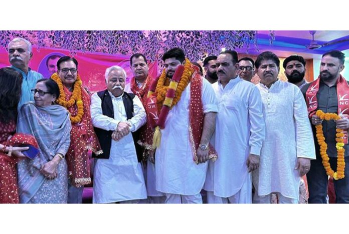 Senior NC leader, Ajay Sadhotra with new entrants during a function at Lower Roop Nagar in Jammu North on Sunday. Senior NC leader, Ajay Sadhotra with new entrants during a function at Lower Roop Nagar in Jammu North on Sunday.