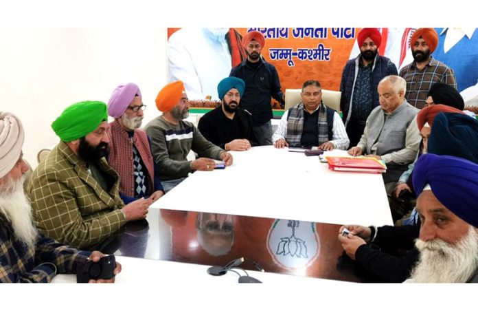 Members of a Sikh deputation in a meeting with J&K BJP chief Sat Sharma and general secretary Ashok Koul.