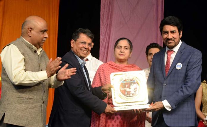 Balwant Thakur presenting a memento to Shantmanu, Addl Chief Secretary Education during a function on Friday.