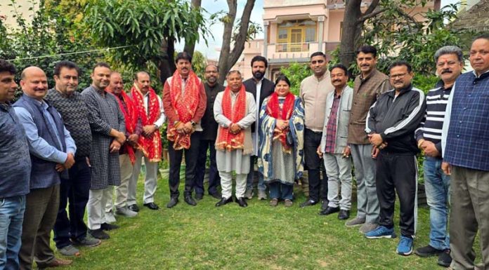 Sat Sharma with party workers during a meeting of the Janipur Mandal.