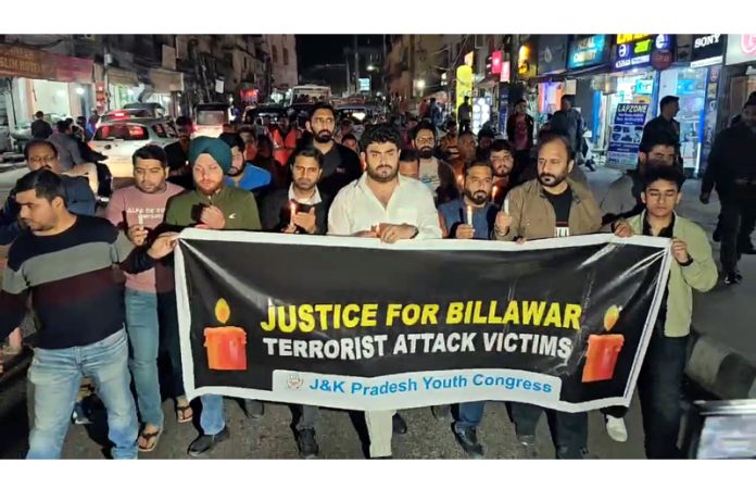 Youth Cong activists taking out candle march against Billawar killings, in Jammu on Tuesday.