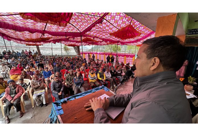 MLA Balwant Singh Mankotia addressing a public meeting during PMAY awareness camp.