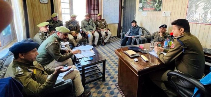 SSP Doda, Sandeep Mehta chairing a meeting at Bhaderwah on Tuesday. -Excelsior/Tilak Raj