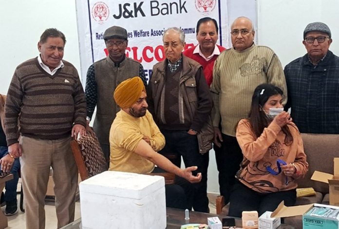 A patient and health expert during a medical camp at Jammu on Sunday.