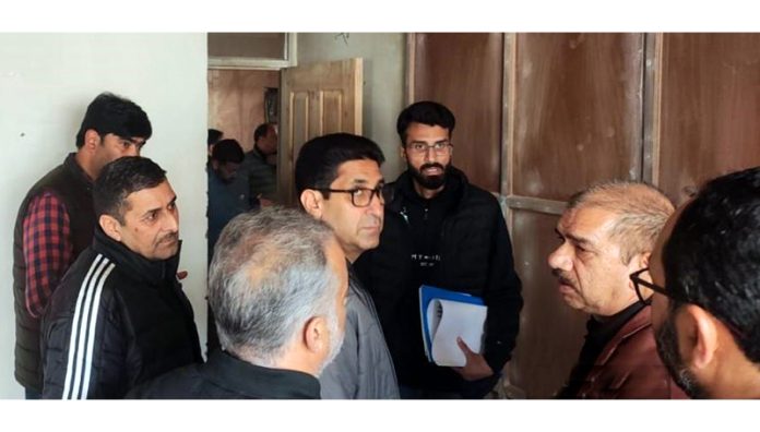 Director H&P interacting with officers while reviewing work.