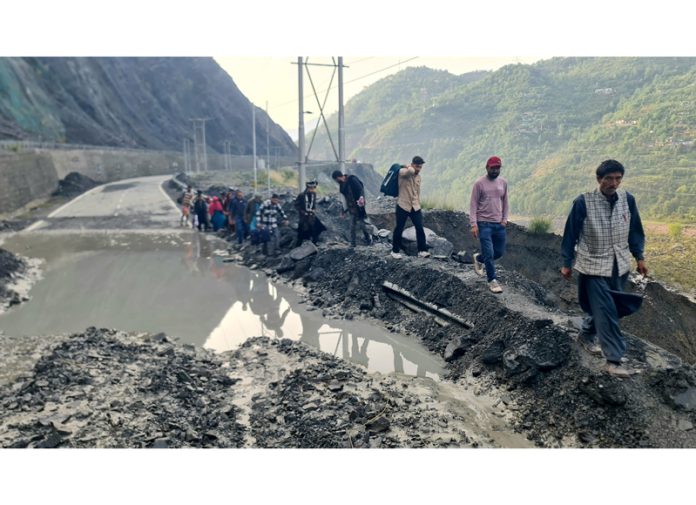 People moving on foot in Ramban area as National Highway remained block due to landslides. -Excelsior/Parvaiz Mir