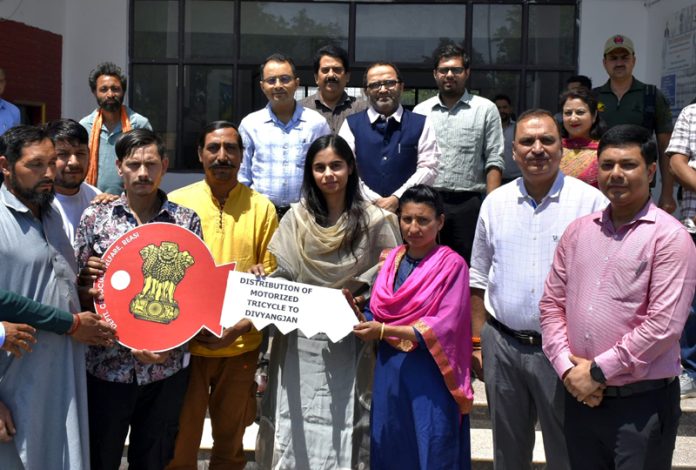 Motorised tricycles being provided to beneficiaries at Reasi.