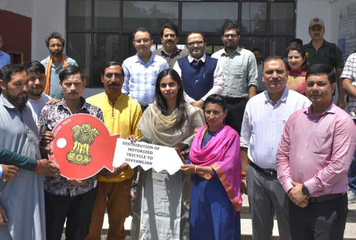 Motorised tricycles being provided to beneficiaries at Reasi.