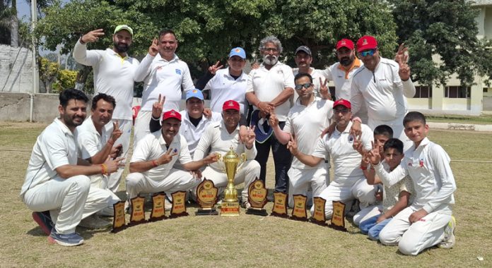 Winning team posing along with trophies.