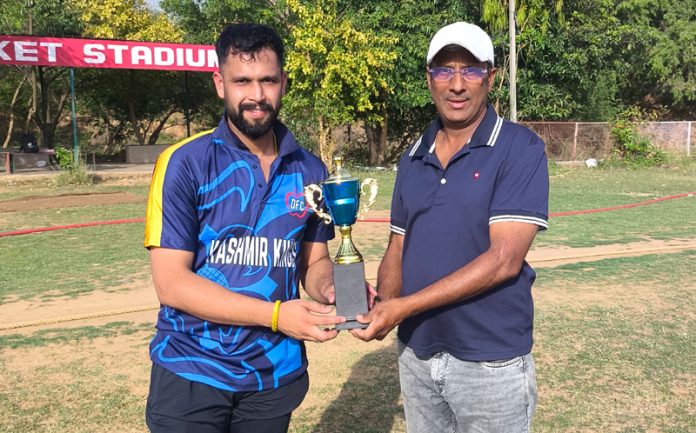 A players receiving man of the match trophy.
